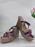 Beige woven espadrille wedge sandals with colorful striped fabric straps and ankle buckle closure.