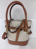 Beige leather bucket bag with brown trim, gold hardware, and double handles.