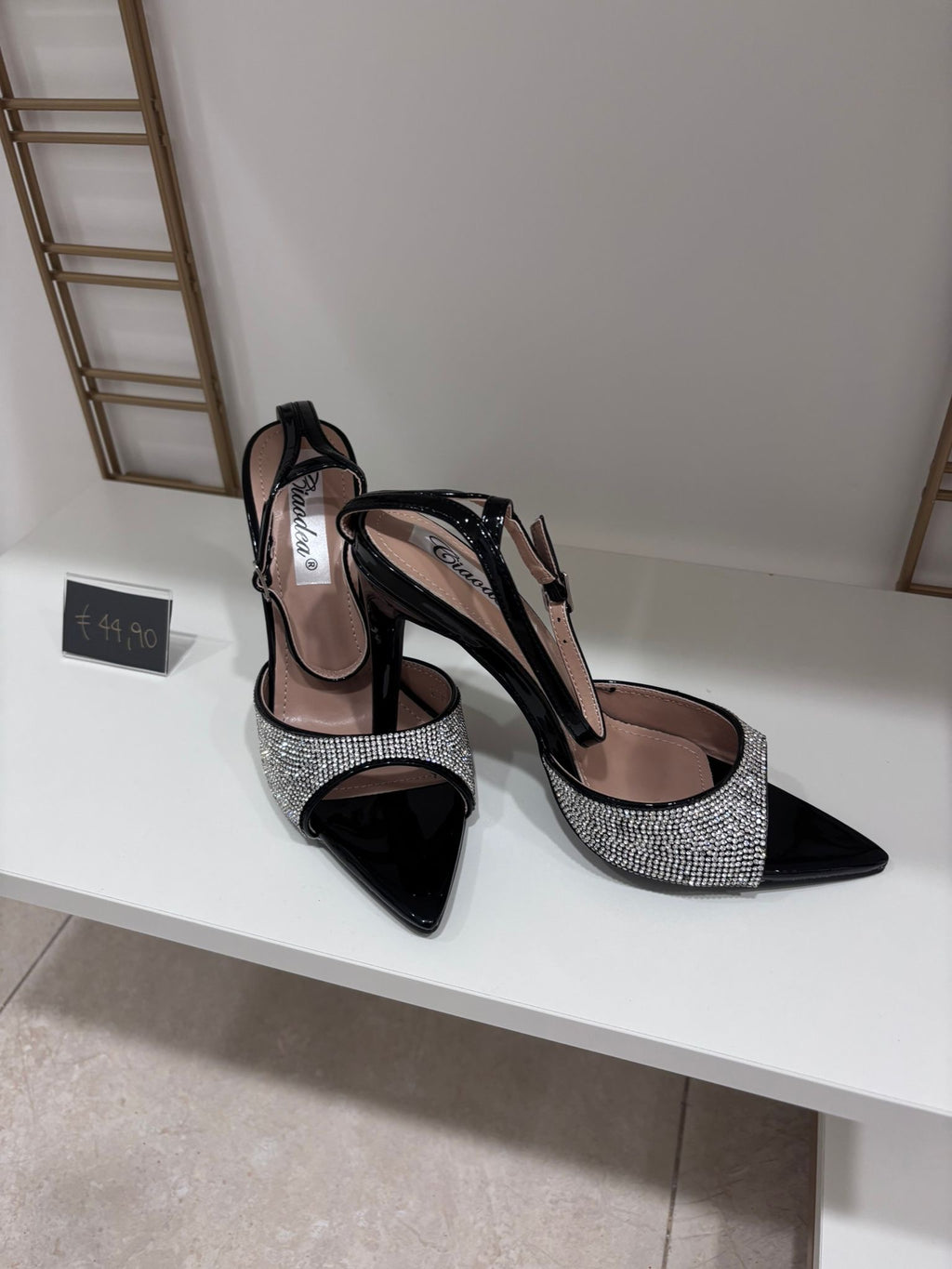 Black pointed high-heeled sandals with silver glitter straps and patent finish.