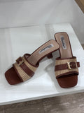 Brown leather mules with woven beige strap and gold buckle, square toe and mid block heel.