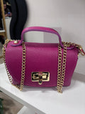 Fuchsia textured leather bag with gold chain strap and rectangular twist-lock closure.