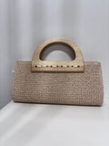 Beige woven straw clutch with curved wooden handle and rectangular shape.