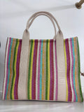 Multicolor striped woven tote bag with beige leather handles and trim.