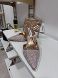 Gold slingback high heel with pointed toe covered in sparkling rhinestones and slim ankle strap.