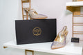 Gold slingback high heels with pointed toe and sparkling crystal embellishments, elegant design.