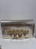 Gold metallic clutch bag with shiny ruffled trim detail on front flap.