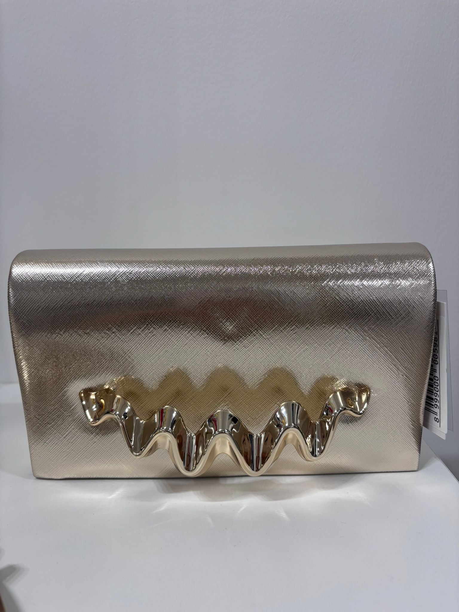 Gold metallic clutch bag with shiny ruffled trim detail on front flap.